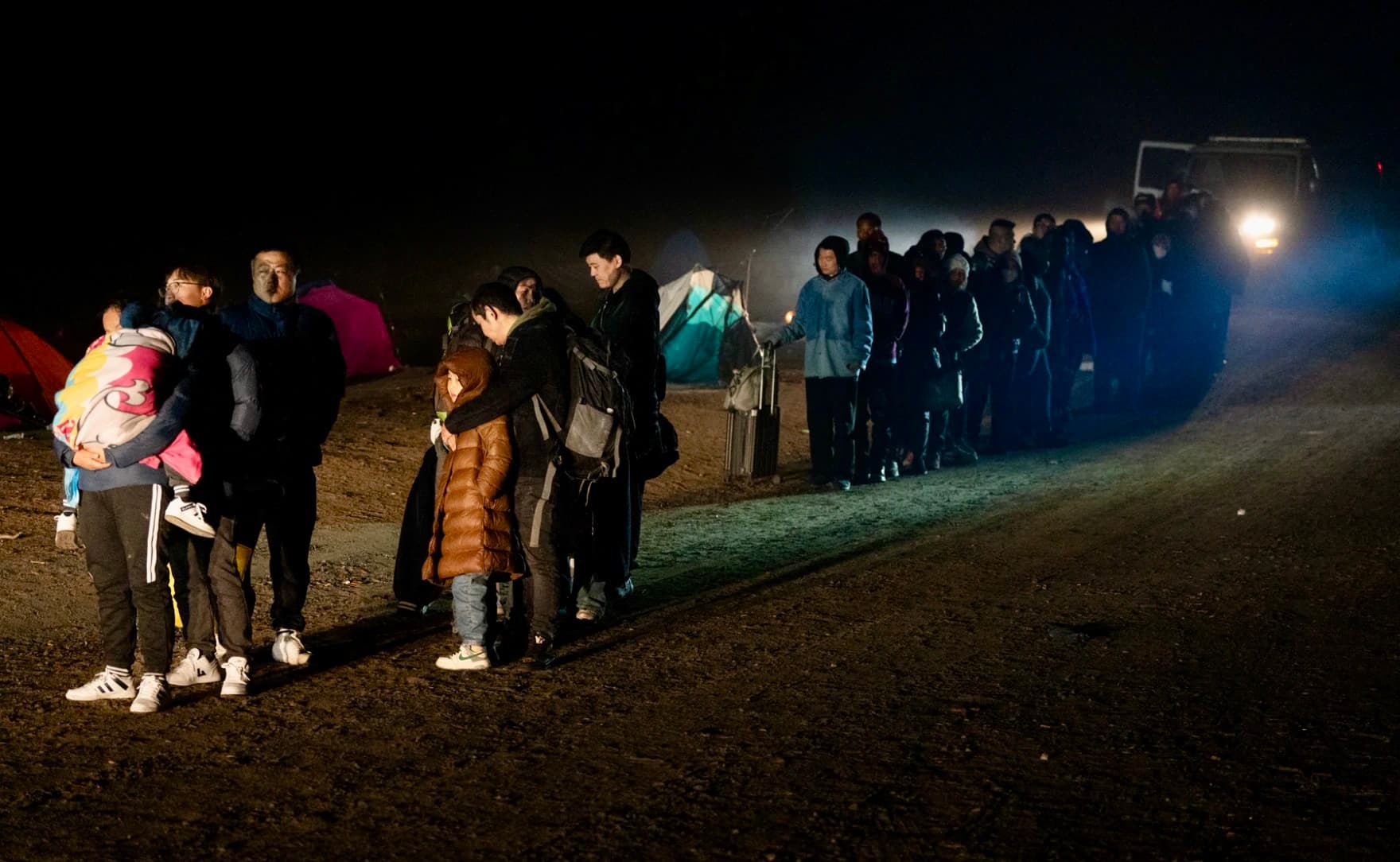 People of all ages lined up in the dark