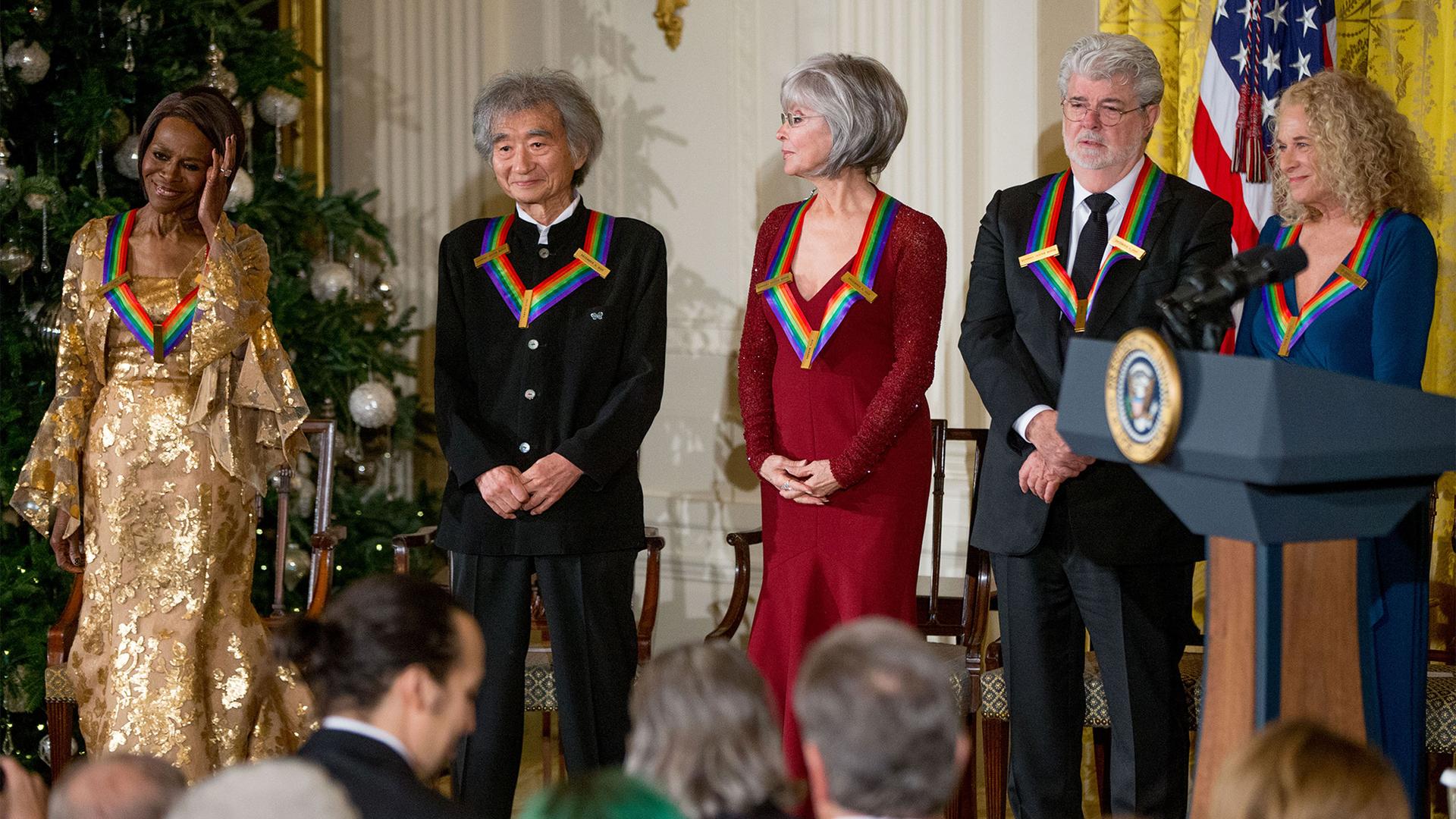 The 2015 Kennedy Center Honors Honorees, including conductor Seiji Ozawa, stand on stage during a reception for them in the East Room of the White House, Dec. 6, 2015.