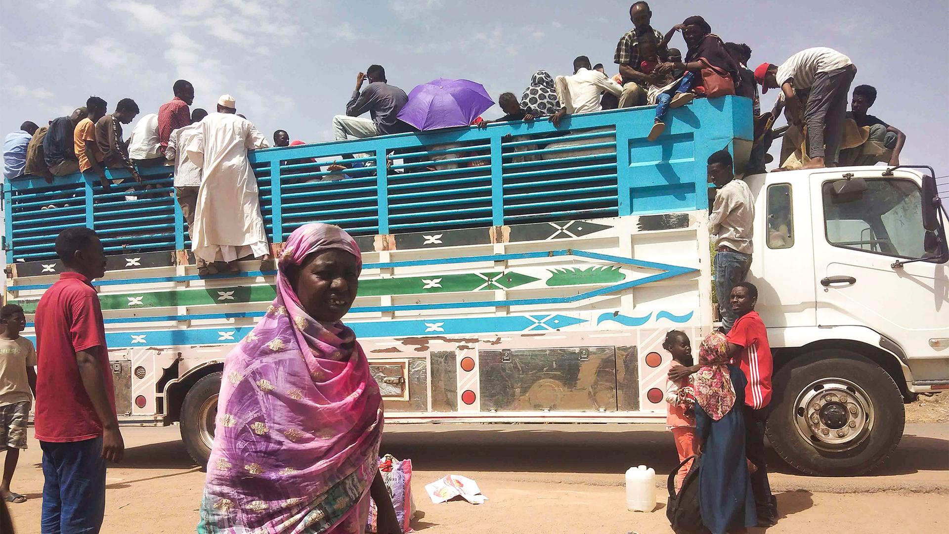 People board a truck as they leave Khartoum, Sudan, on June 19, 2023.
