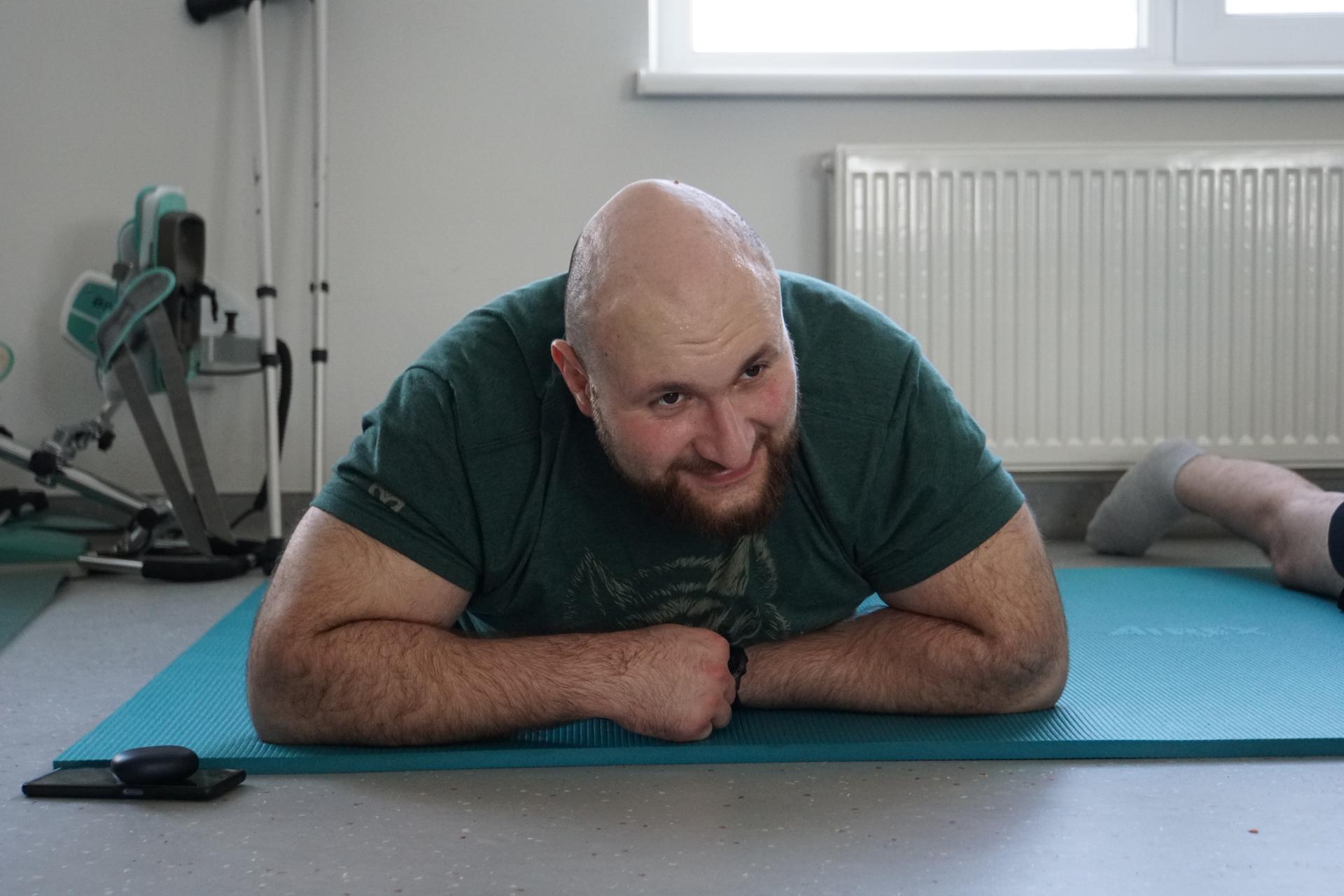 Oleksandr stretches at the Unbroken National Rehabilitation Center in Lviv, Ukraine.