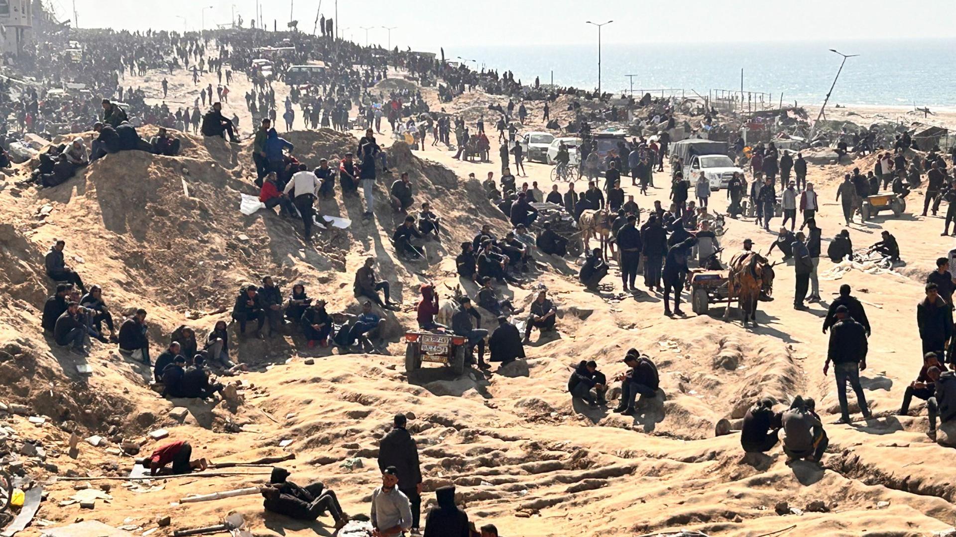 Palestinians wait for humanitarian aid on a beachfront in Gaza City, Gaza Strip, Feb. 25, 2024.