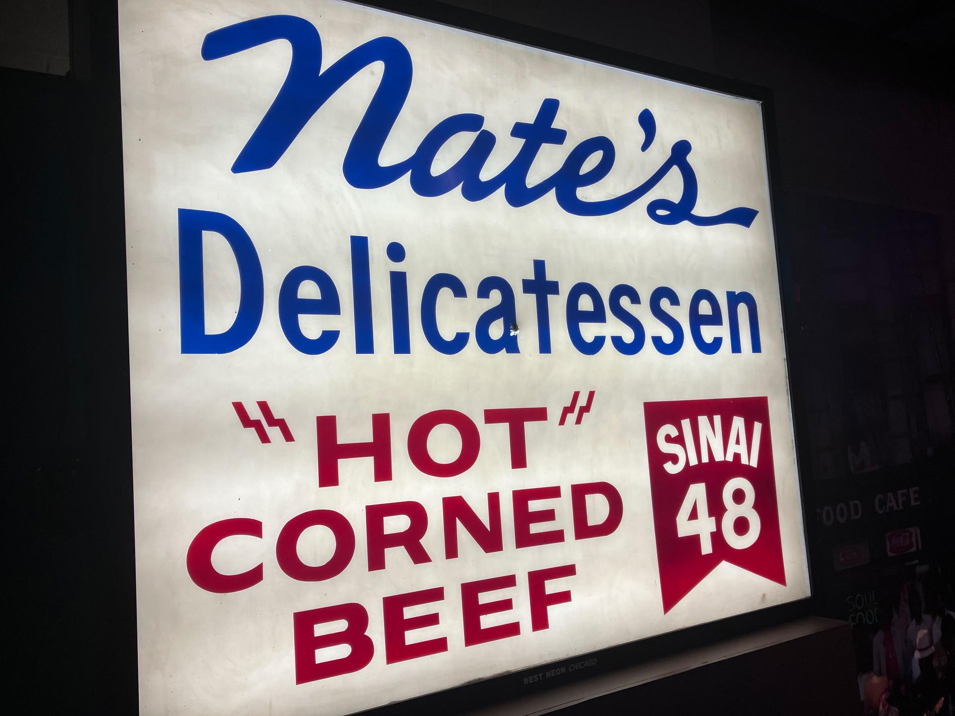 A sign from the former Nate’s Deli appears in the exhibition, 