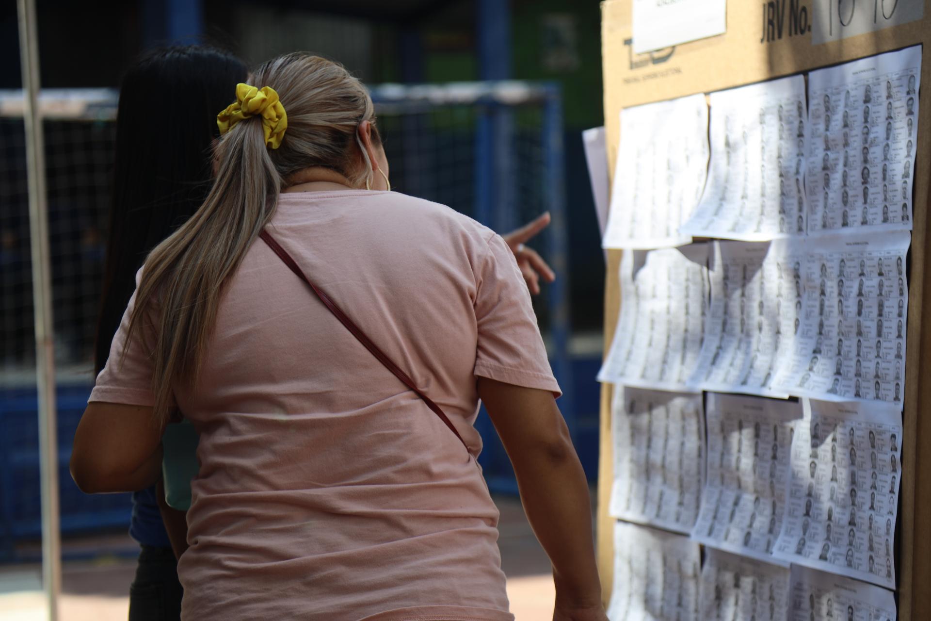 A woman heads to a polling station to vote in El Salvador's elections, Feb. 4, 2024.
