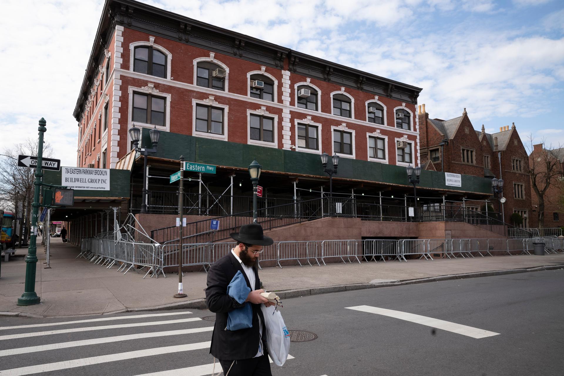 A man passes the Chabad-Lubavitch World Headquarters in the Crown Heights neighborhood of Brooklyn in New York, April 7, 2020.