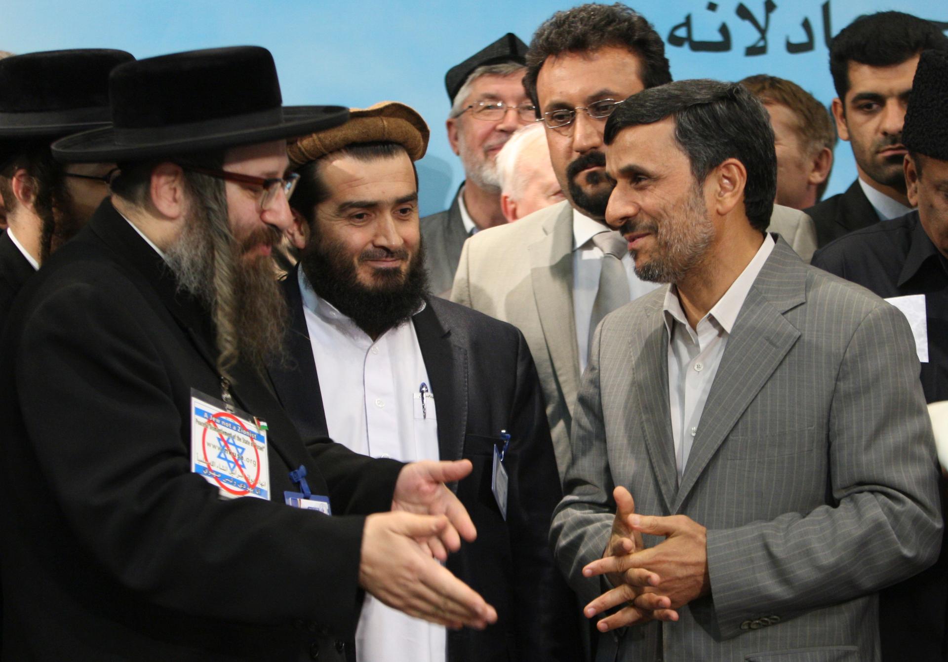 Iranian President Mahmoud Ahmadinejad listens to anti-Zionist rabbi Yisroel Dovid Weiss in Tehran, Iran.