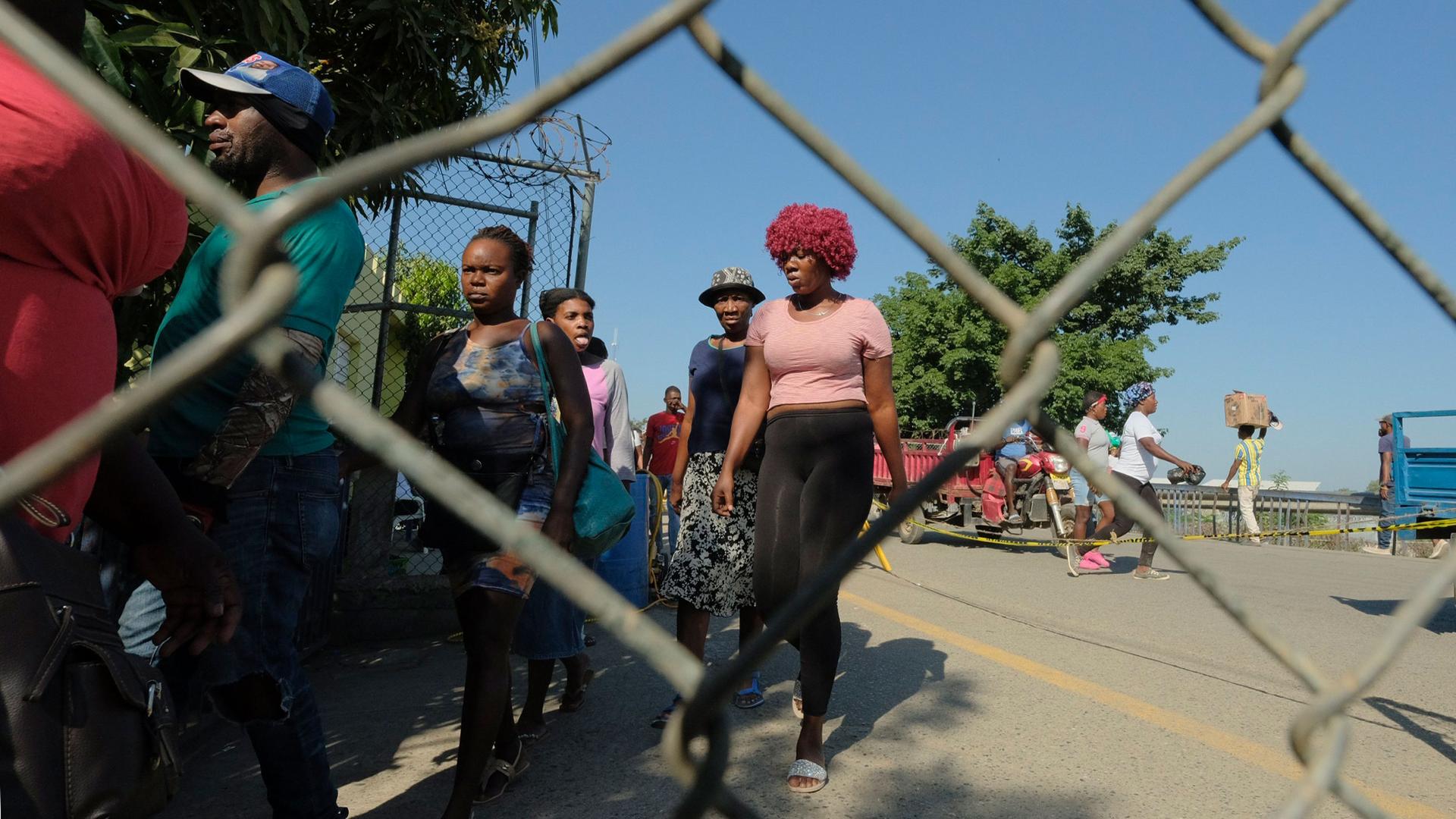 People line up at the border bridge in Quanaminthe, Haiti, on their way to the binational market in Dajabon, Dominican Republic, March 18, 2024.