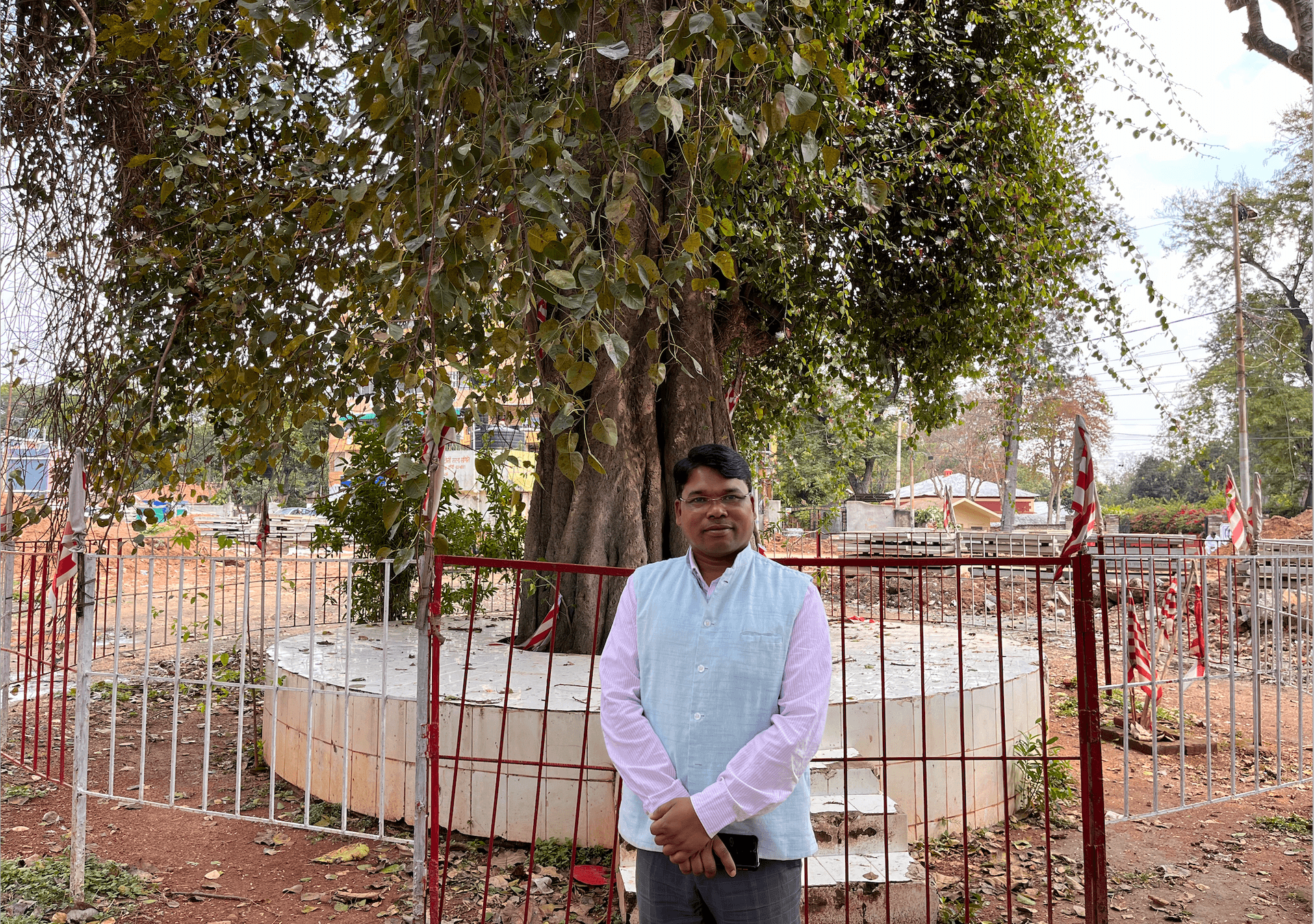 Mathura Kandir, a member of the Mundra tribe, stands in front of a sacred grove in Ranchi, a place of worship for India's Indigenous people, or Adivasis.
