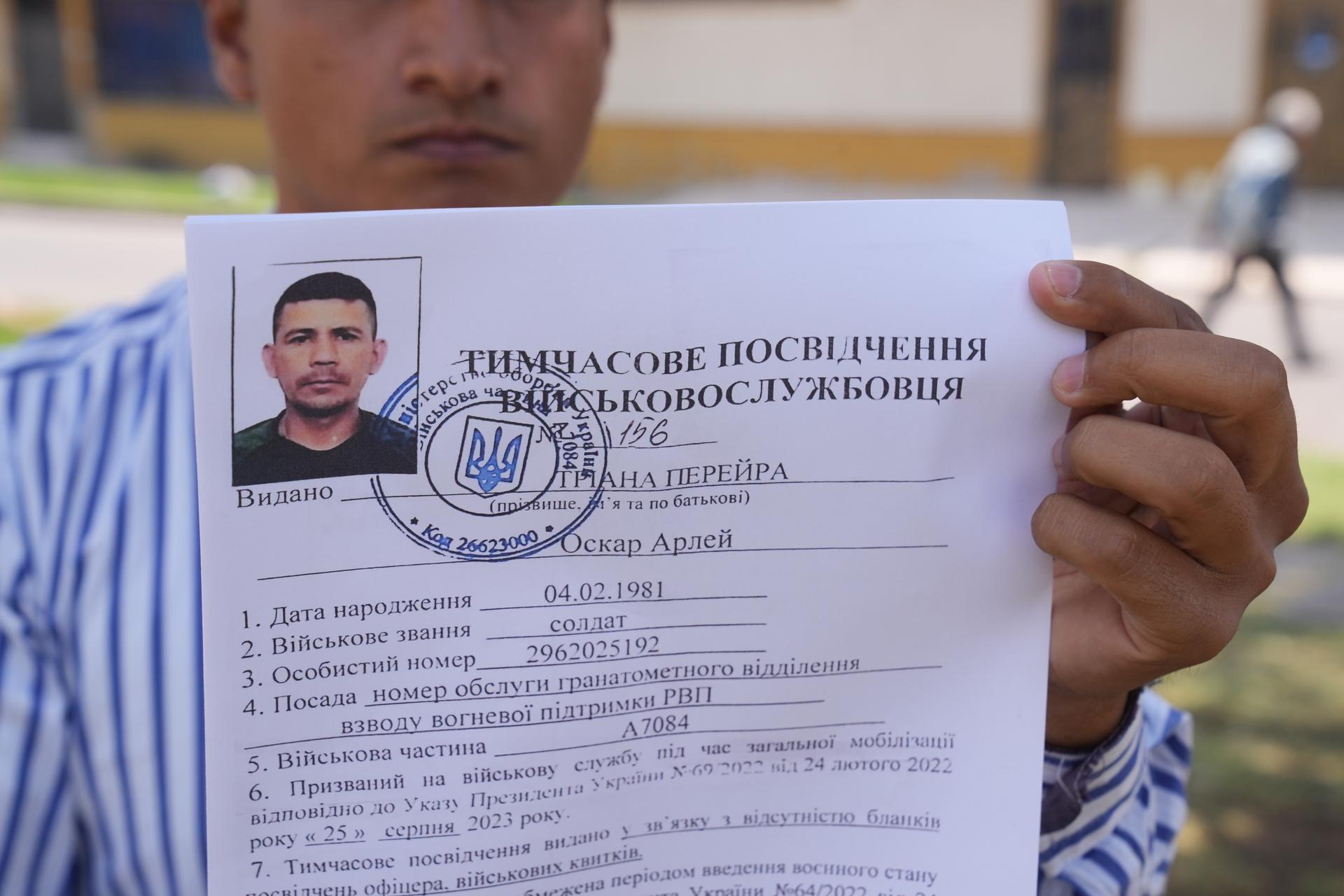 Diego Espitia holds documents sent to his cousin, Oscar Arley Triana, after he enlisted in Ukraine’s army. Triana arrived in Ukraine last summer but he went missing  in October during an ambush near the city of Kupiansk.
