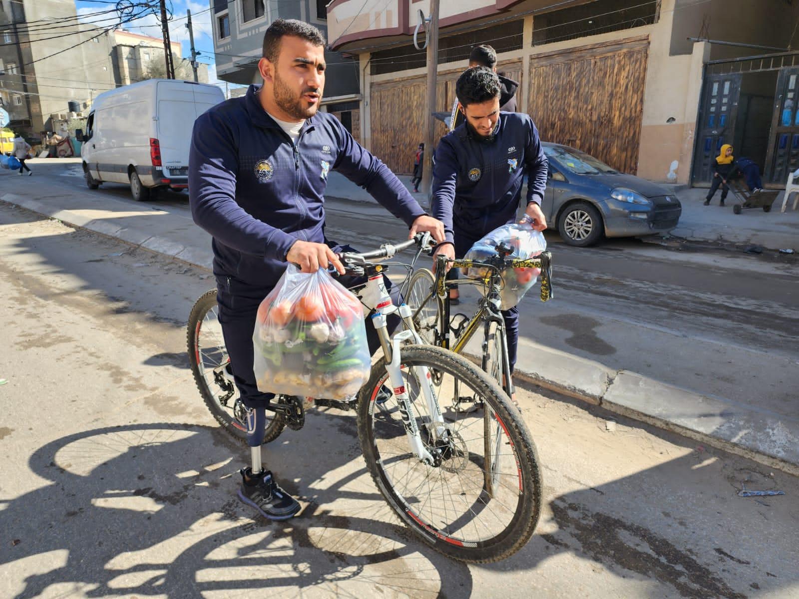 Gaza Sunbirds paracycling team members deliver much-needed food and other supplies in Rafah, Gaza. 