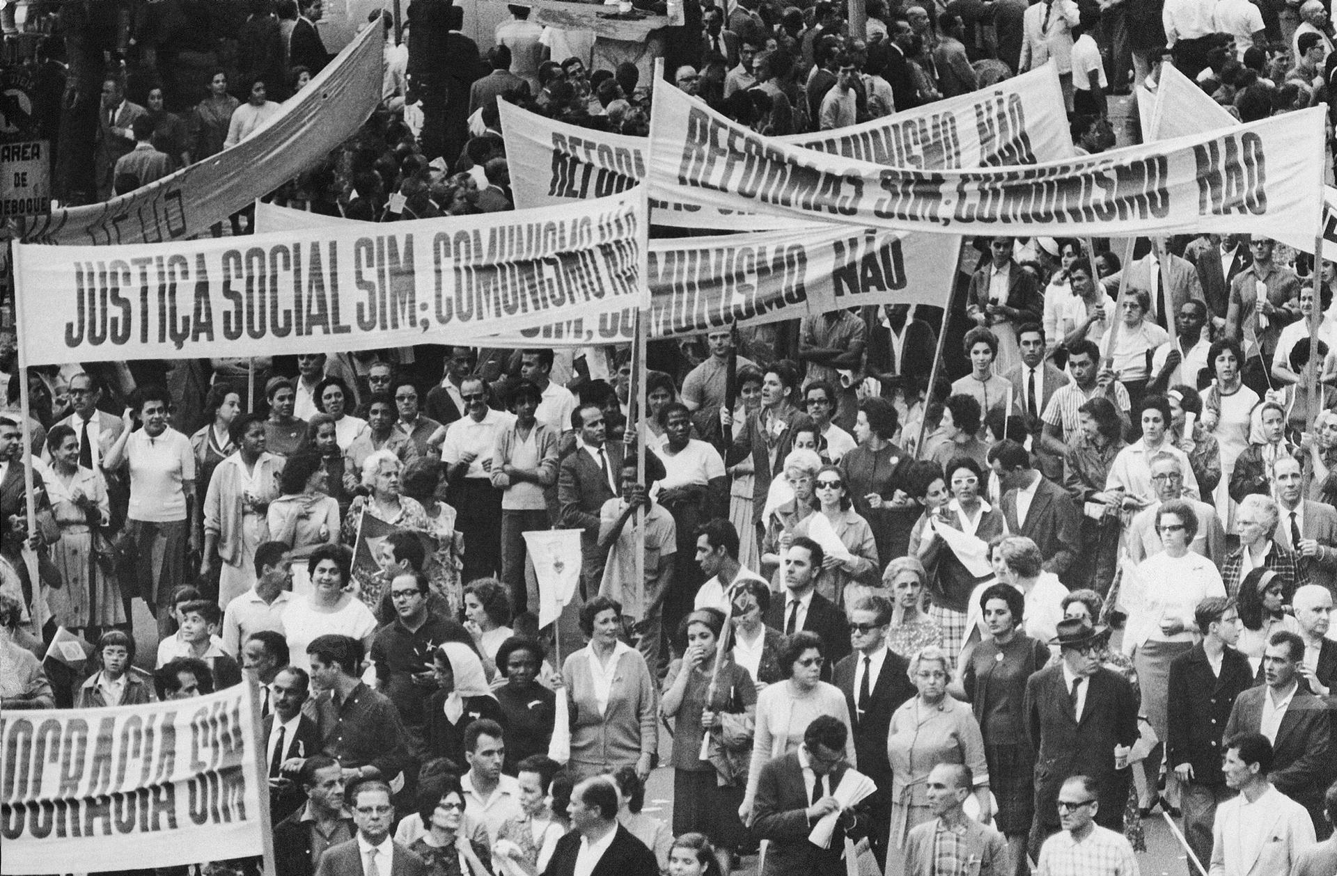 Brazilians demonstrate in the street, April 1964. Sign at left reads 