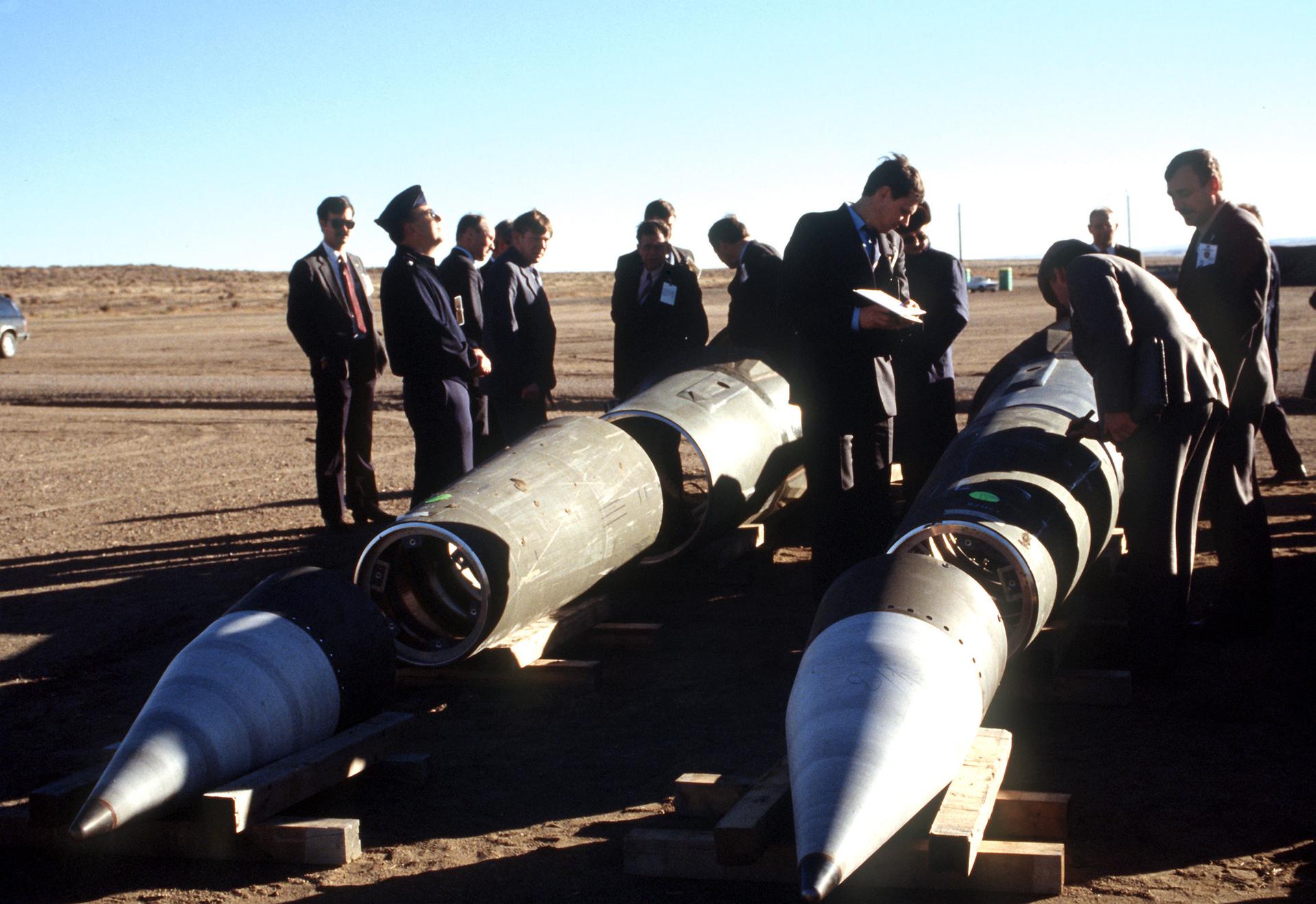With their American escorts watching, Soviet inspectors examine Pershing II missiles on Jan. 14, 1989, prior to their destruction in accordance with the Intermediate-Range Nuclear Forces Treaty.
