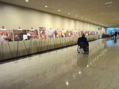 John Hockenberry, host of PRI's The Takeaway, visits the exhibit of Ceasar's photos at UN headquarters in New York.
