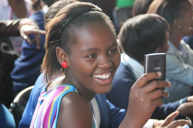 Bridgit, a junior at COSAT, and some of her classmates read books on their cell phones.