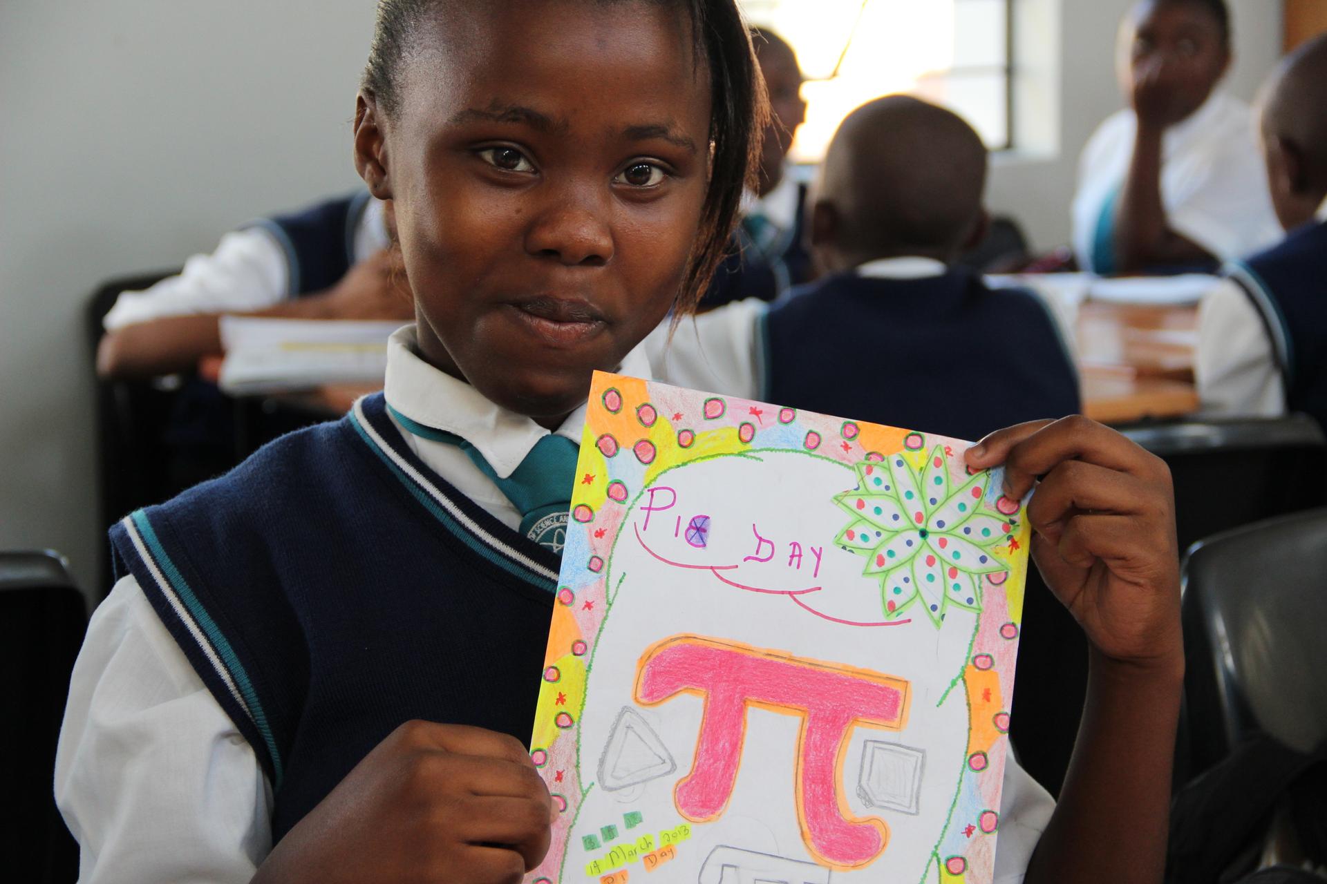 Zizipho, an 8th grade student, displays her Pi Day poster.