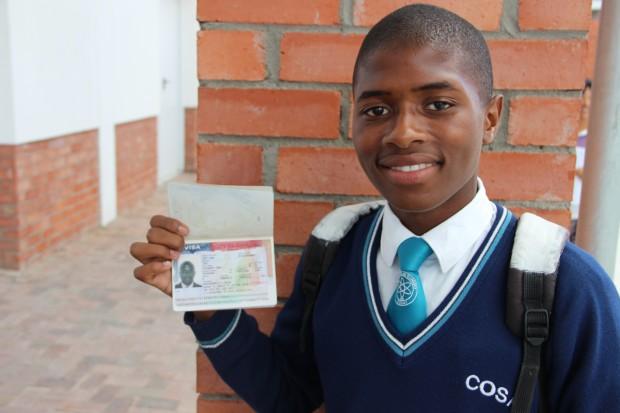 Sive, an eleventh-grader, holds up his US travel visa.