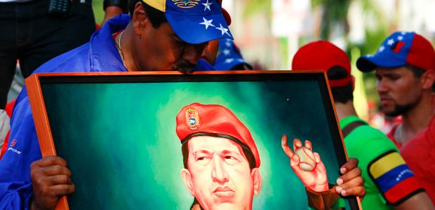 Venezuela's president, then-presidential candidate, Nicolás Maduro kisses a painting of late Venezuelan president Hugo Chávez during a campaign rally in the state of Vargas, April 9, 2013.