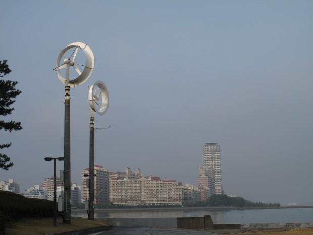 Two experimental "wind lenses" rise over a park in Fukuoka, Japan.