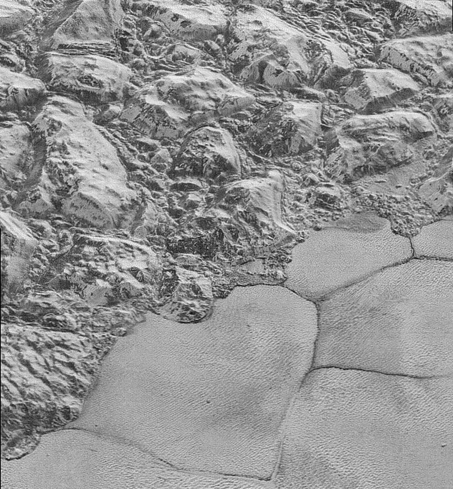In this highest-resolution image from NASA’s New Horizons spacecraft, great blocks of Pluto’s water-ice crust appear jammed together in the informally named al-Idrisi mountains. Image by NASA/JHUAPL/SwRI