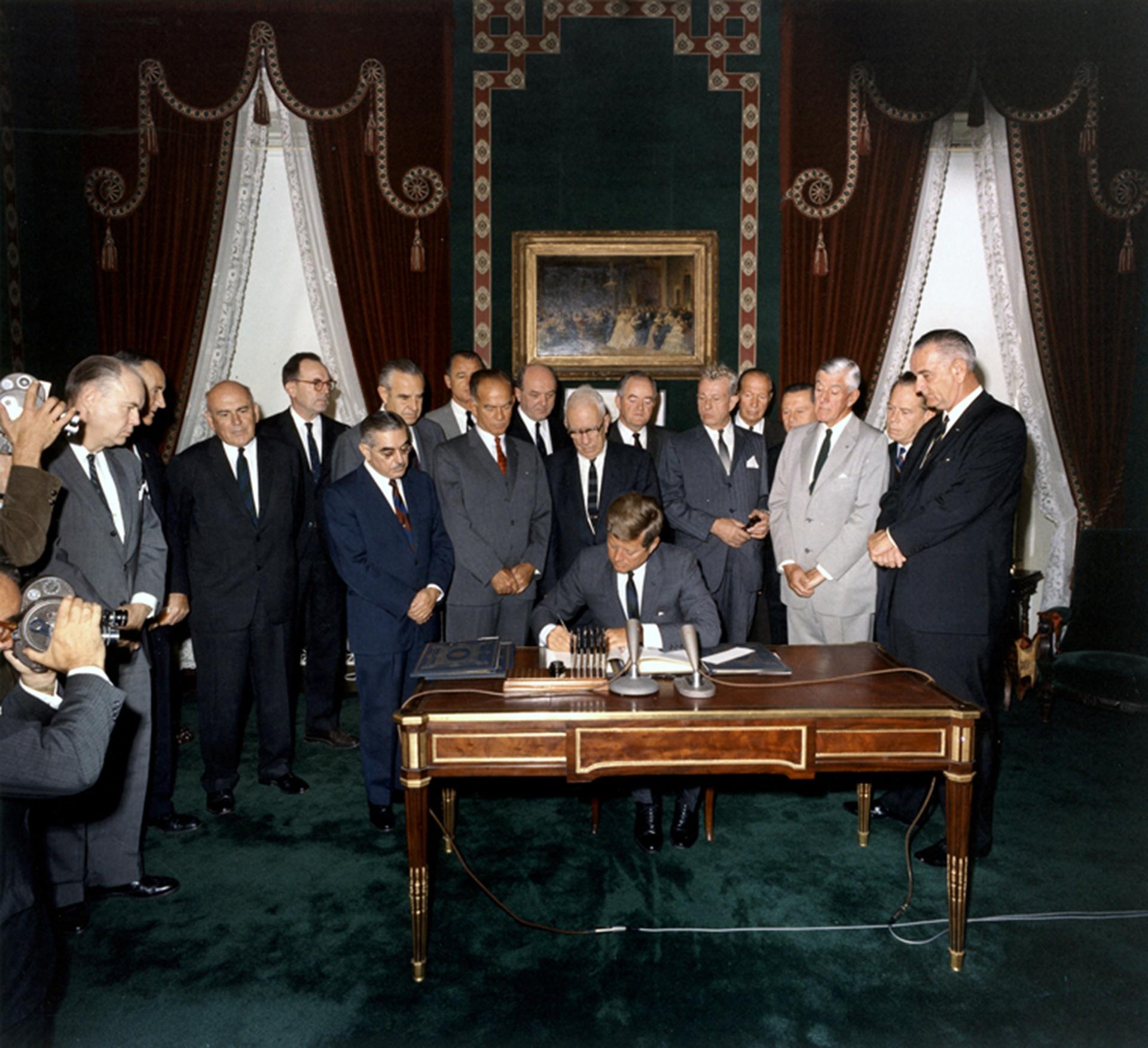 President John F. Kennedy signs Nuclear Test Ban Treaty on Oct. 7 1963.