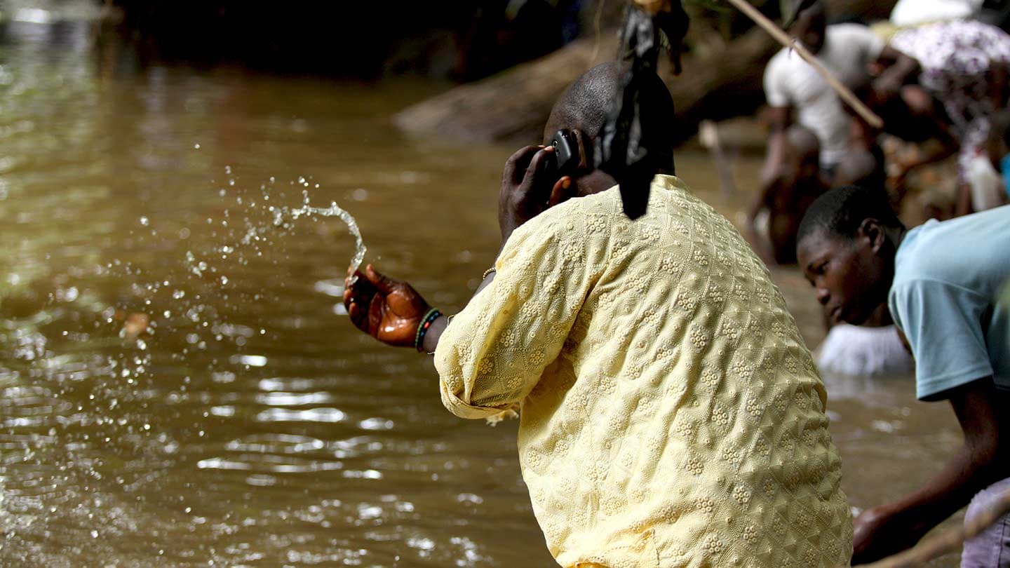 A pilgrim participates in the cleansing ritual at Osun’s Sacred Grove during the festival of Osun-Osogbo.