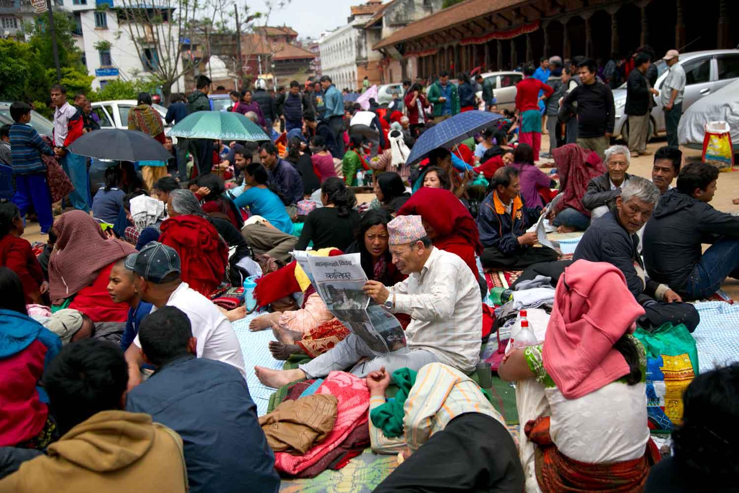 Nepalese waiting in open areas away from buildings, at Patan Durbar square, the day after the quake