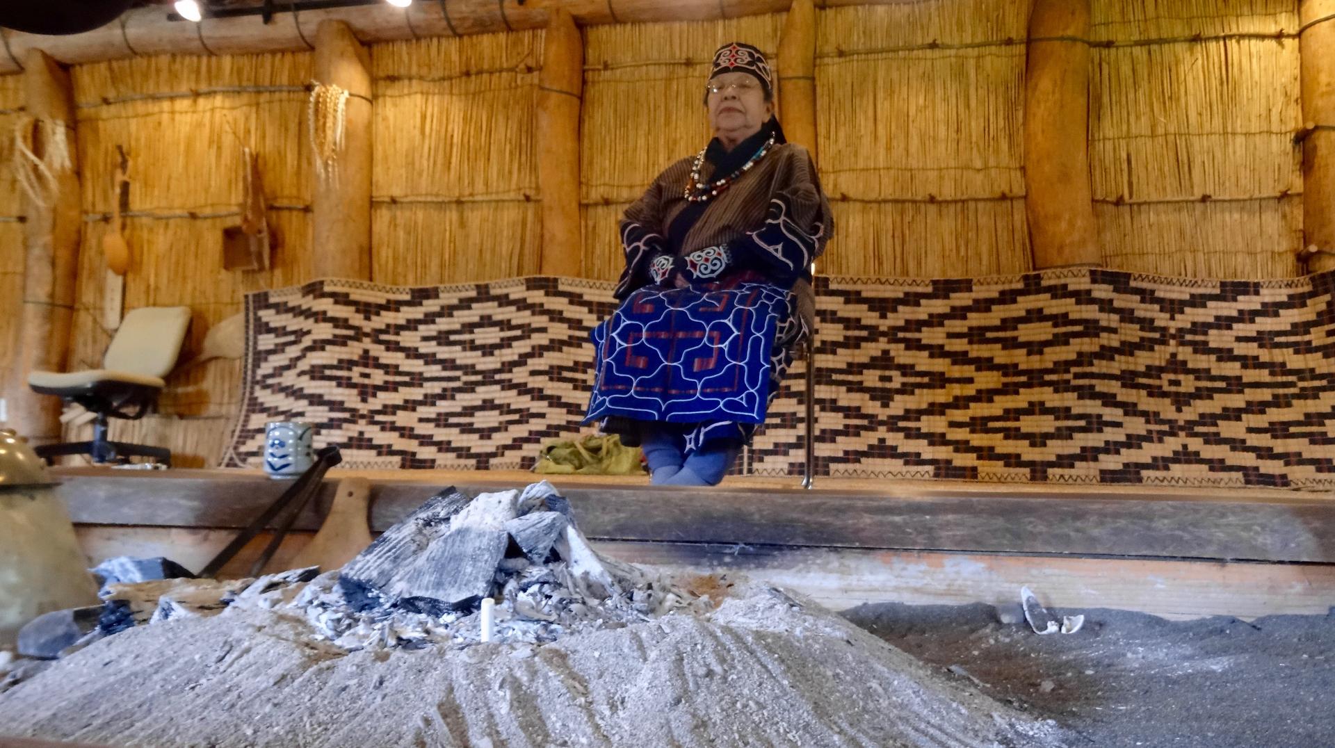 Kibata Sachiko recites an Ainu epic poem taught to her by her grandmother. She is in reconstructed Ainu dwelling in Nibutani, Japan.