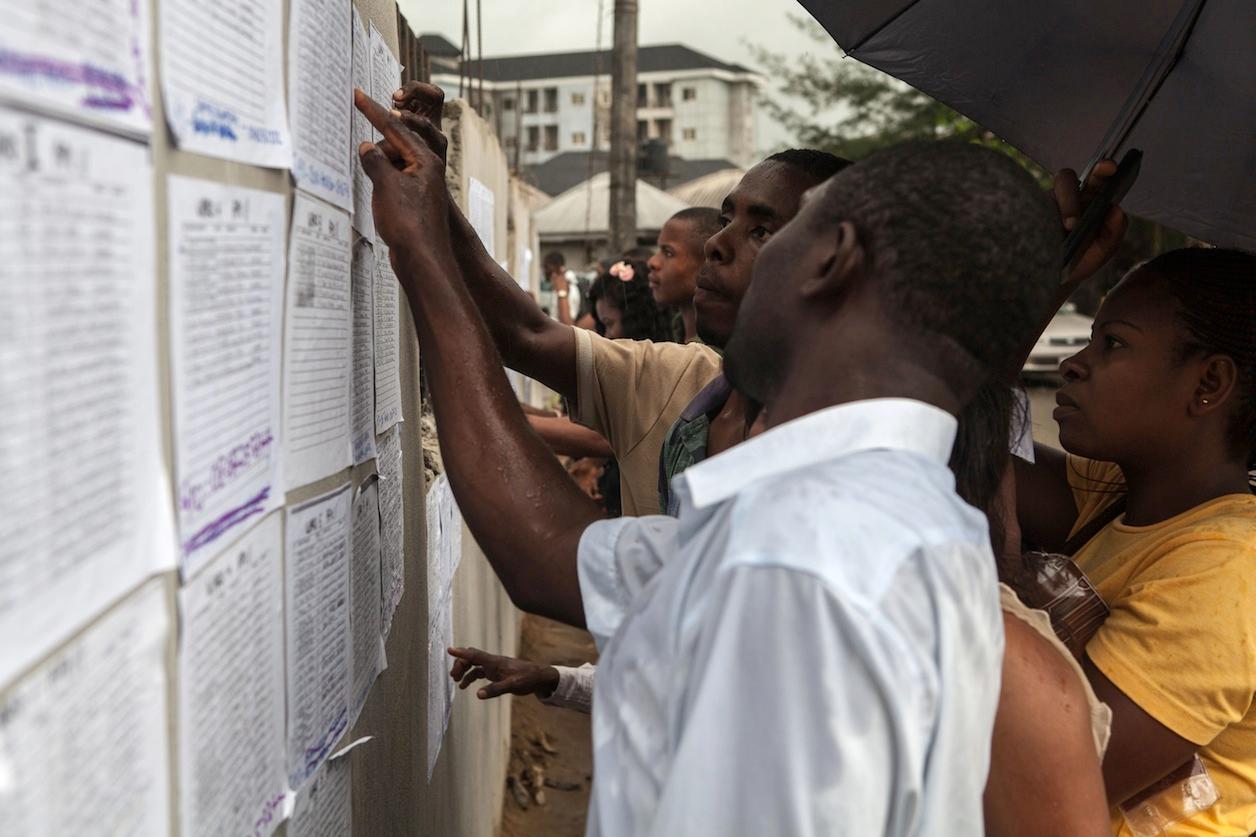 Volunteers check their ballot station positions in the Bayelsa state capital of Yenagoa on the eve of Nigeria's presidential election.