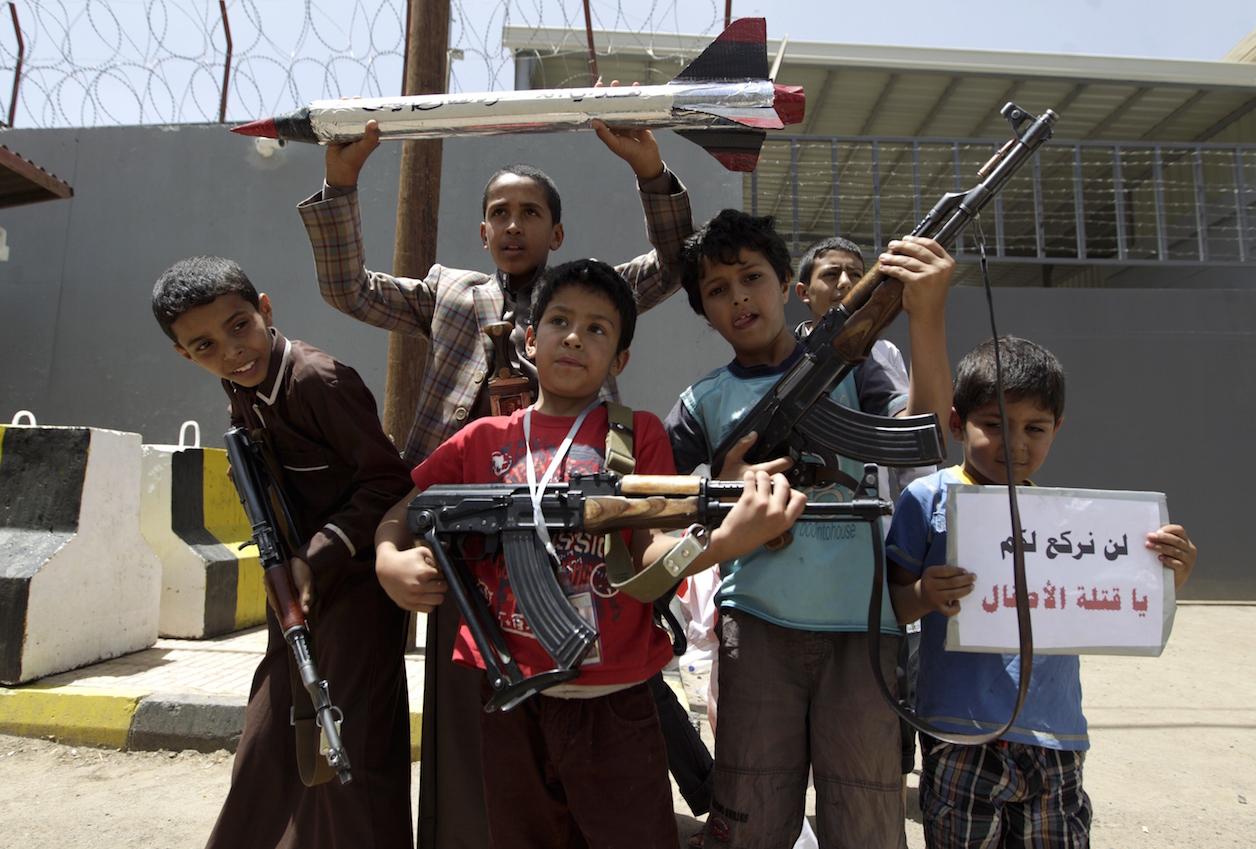 Yemeni children pose for a photo during a protest in front of the United Nations office in Sanaa on April 13, 2015 against a strike by the Saudi-led coalition the previous day.