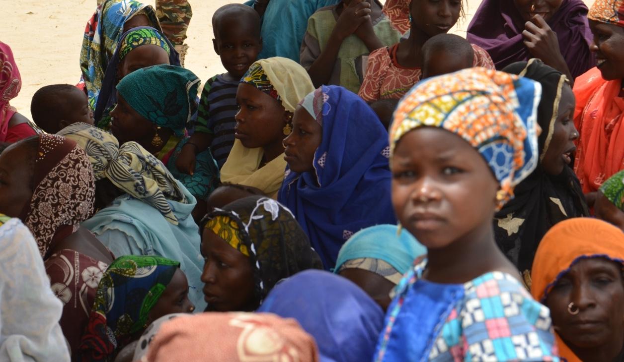 A picture taken on April 3, 2014 in Maine-Soroa, eastern Niger, shows Nigerian people gathered at a camp for refugees who fled the fighting between the Nigerian army and Boko Haram.