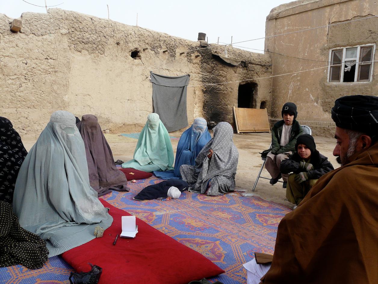 Women of Hutal village discuss building a women's center with the Maiwand District governor.