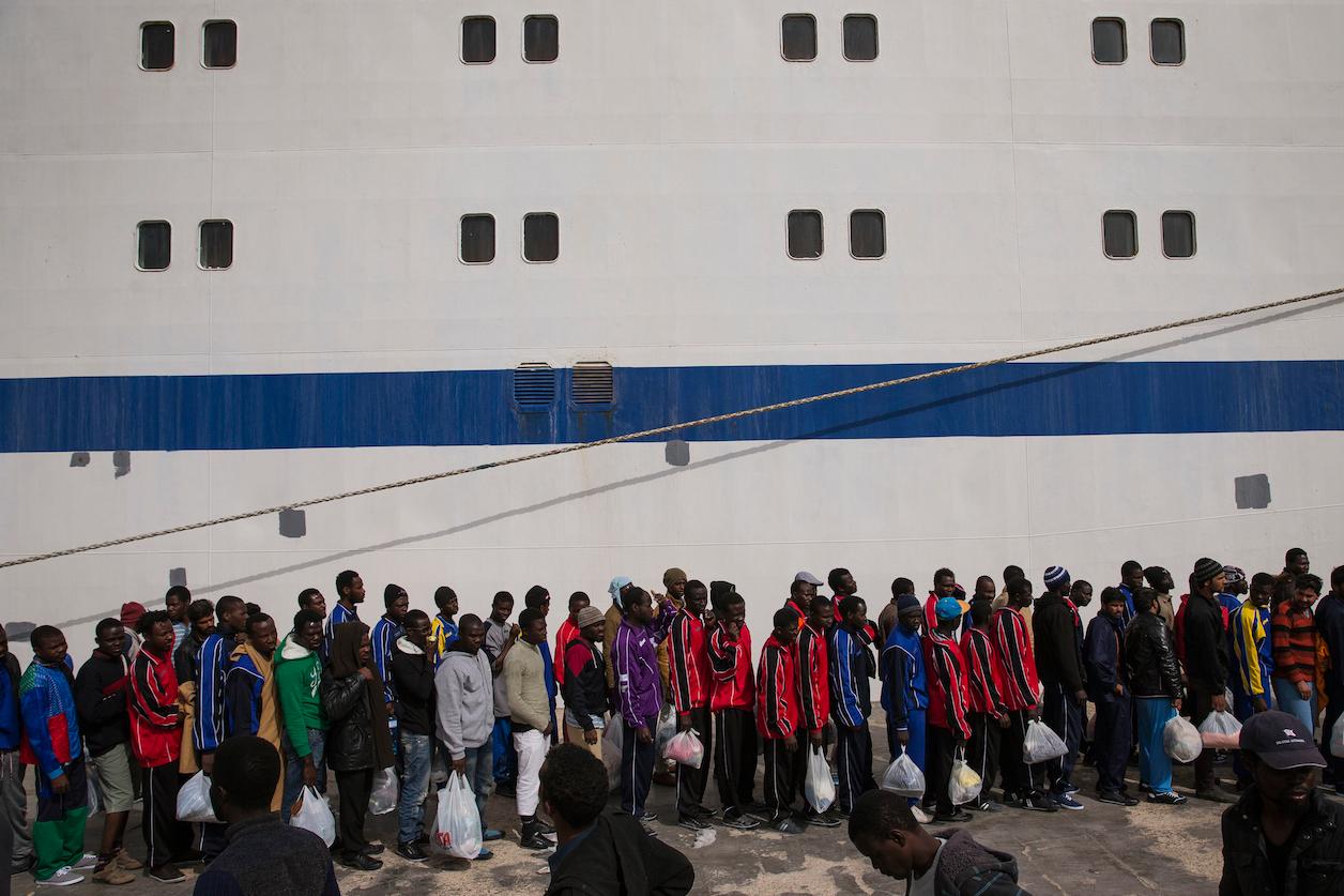 Migrants from North Africa wait for transfer in Italy.