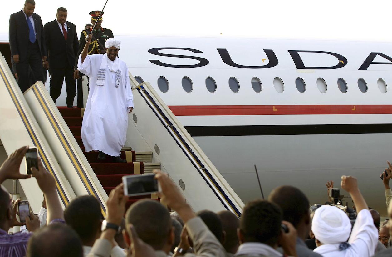 Sudanese President Omar al-Bashir disembarks from his private plane in Khartoum