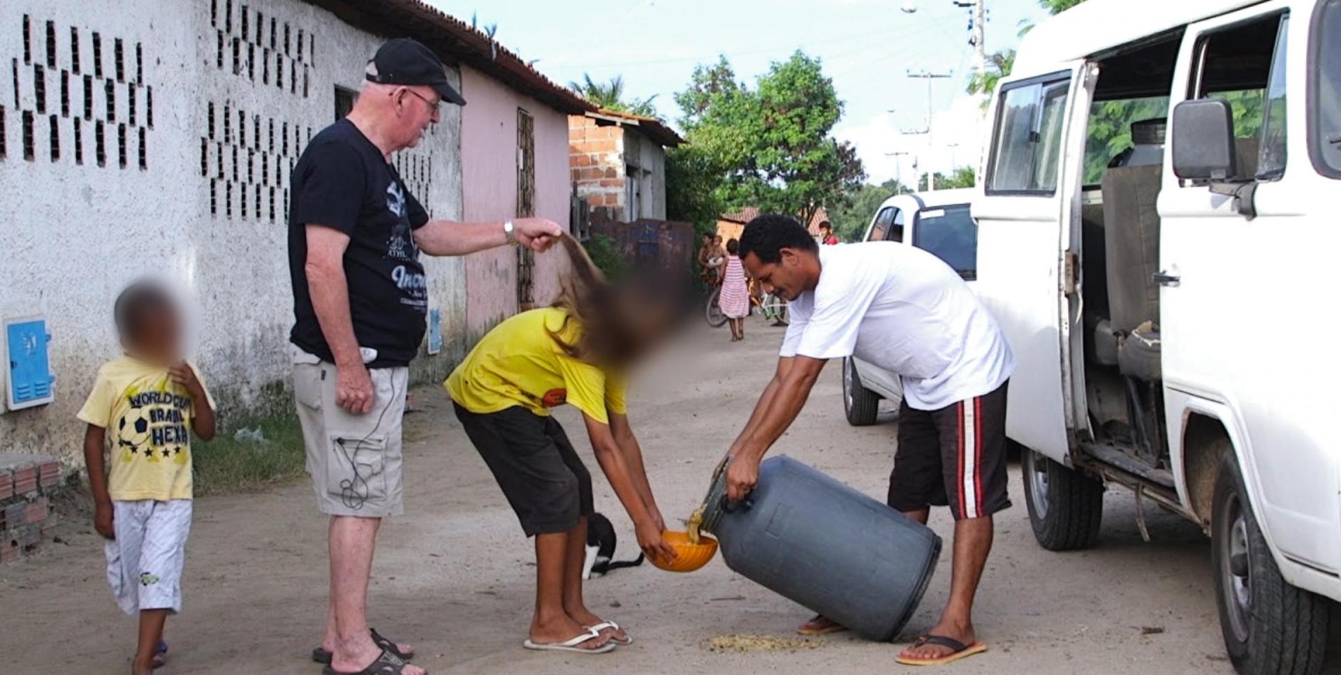 Priest Jan Van Dael touching a boy's hair in Brazil