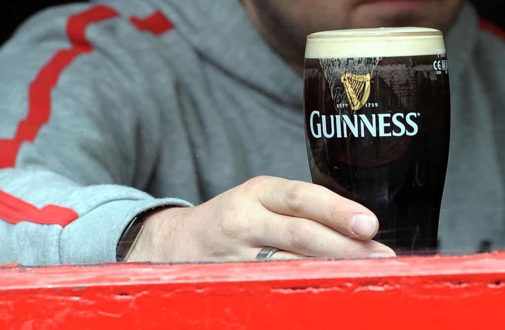 A man drinks a pint of Guinness in Dublin on May 20, 2011.