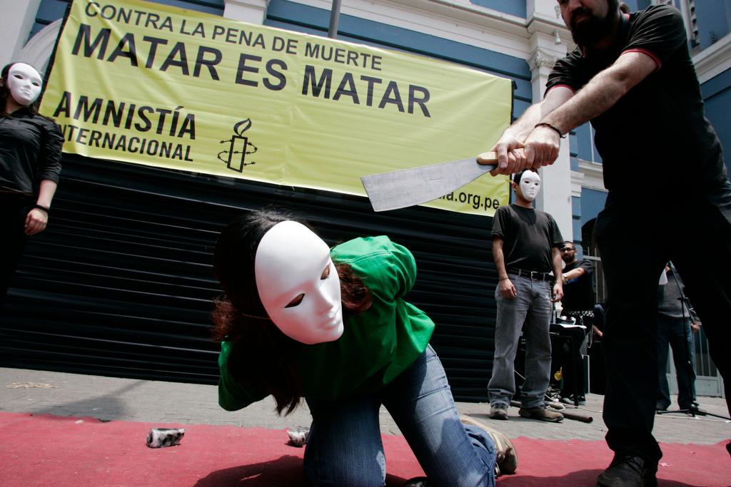 Activists from Amnesty International perform a beheading during a demonstration for "World Day Against the Death Penalty" on a street in Lima on Oct. 10, 2007.