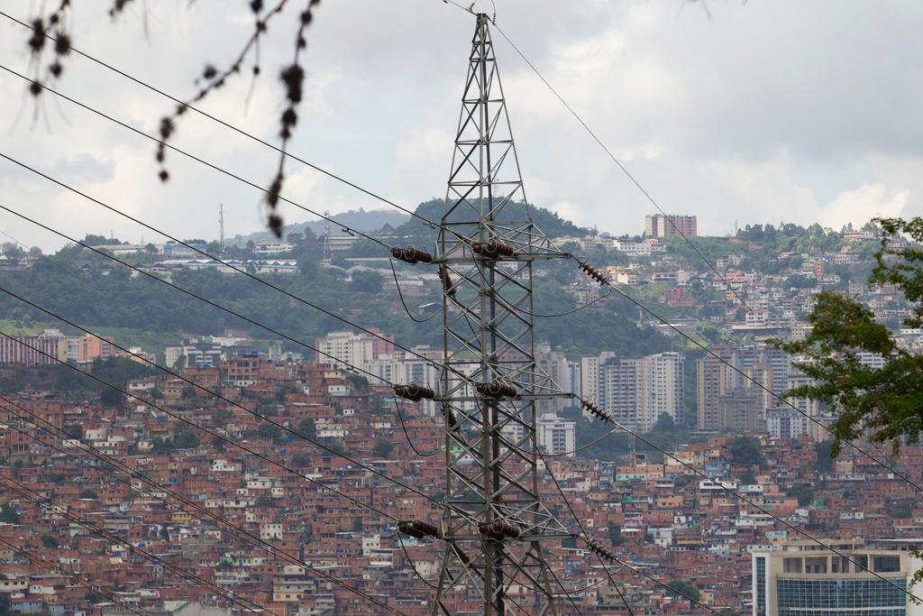 An electricity pylon and power lines are seen in Caracas, Venezuela, on June 9, 2011.