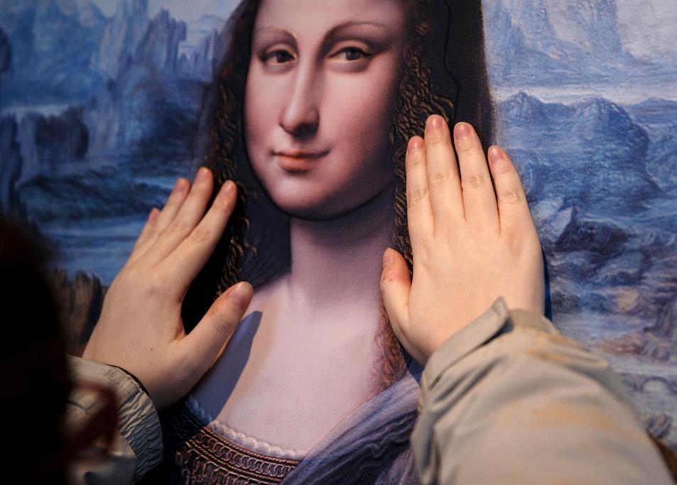 A visually impaired visitor touches a work representing Leonardo da Vinci's Mona Lisa at an exhibition called 'Touching the Prado' at the Prado museum in Madrid, on Feb. 13, 2015.