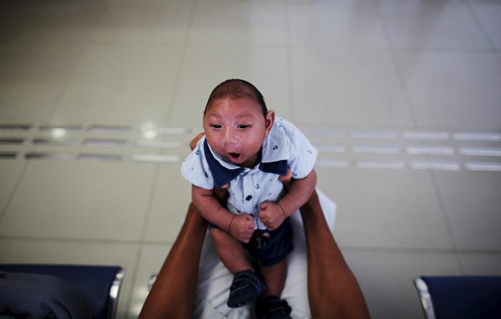 Geovane, 32, holds his son Gustavo Henrique who is two-months old and born with microcephaly, as they wait for a session with a physiotherapist at the Altino Ventura rehabilitation center in Recife, Brazil, on Feb. 11, 2016.