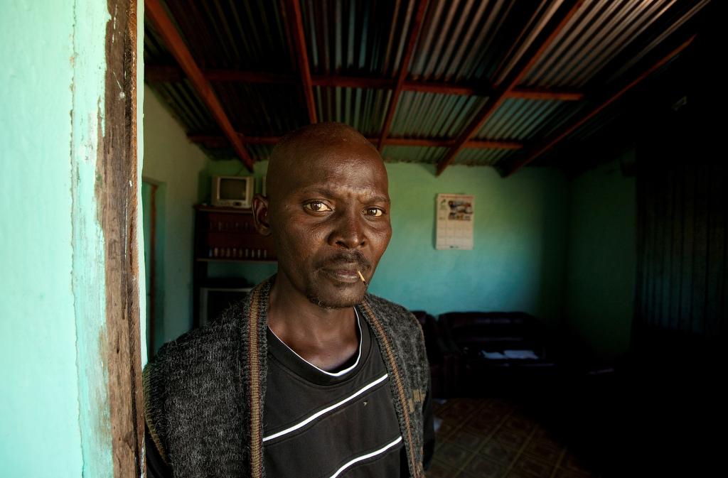 Former gold miner Thulani Bitsha, 39, who contracted silicosis while working underground, stands in the doorway to his home near Bizana in South Africa's impoverished Eastern Cape province, March 7, 2012.