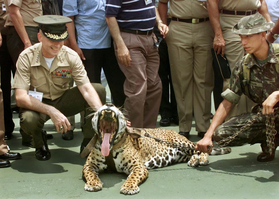 General Peter Pace, Commender-in-Chief of the Southern Command forces of the United States (L), gets a close look at a jaguar at Brazil's jungle warfare training center outside of Manaus, in the Amazon basin, October 19, 2000.