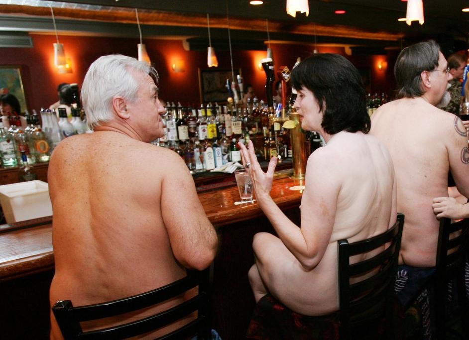 A group of nudists socialize at a bar before dining together at a "Clothing Optional Dinner" at a New York City restaurant on Feb. 17, 2005.