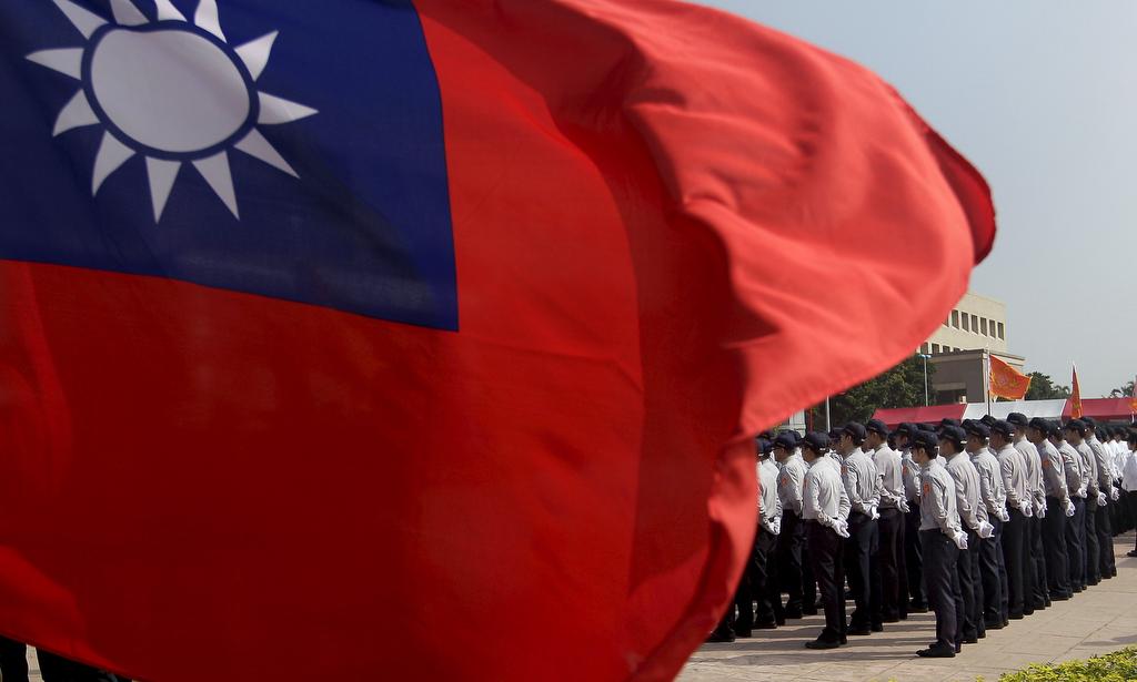Members of the National Security Bureau take part in a drill next to a national flag at its headquarters in Taipei, Taiwan, November 13, 2015.