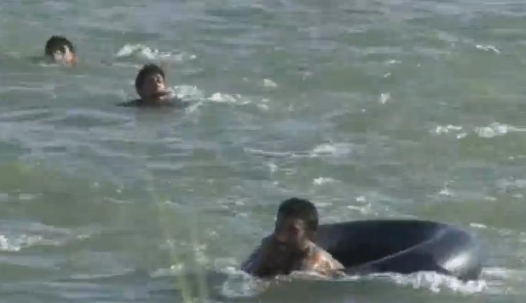 A still image from video released June 6, 2016 shows Iraqi families attempting to escape the besieged city of Falluja, Iraq, by crossing the Euphrates river, June 3, 2016.