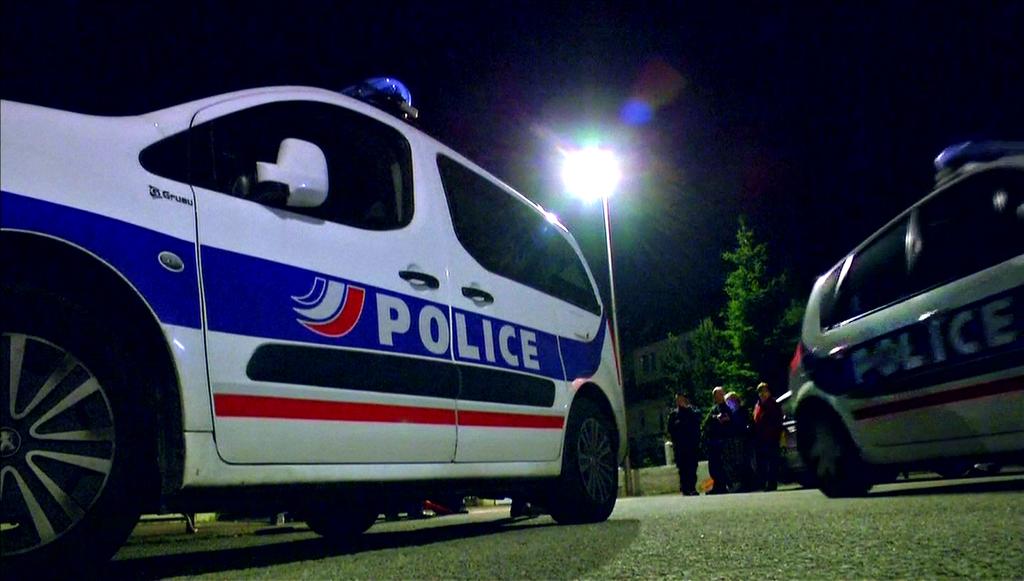 A still image taken from video shows police vehicles at the scene near where a French police commander was stabbed to death in front of his home in the Paris suburb of Magnanville, France, on June 14, 2016.