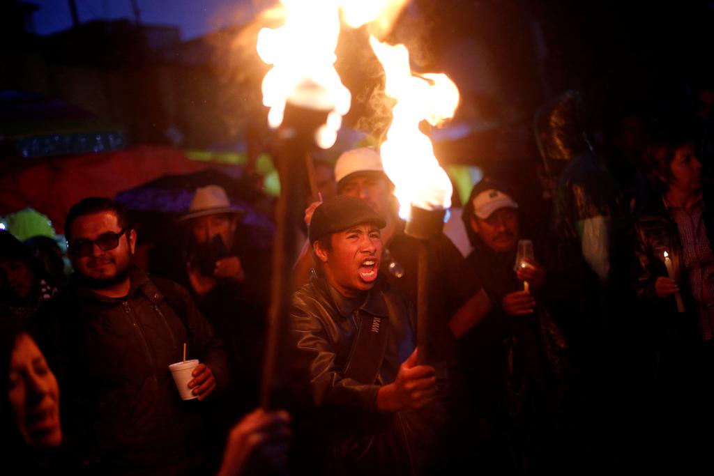 A protester from the National Coordination of Education Workers (CNTE) teachers' union holds a torch as he yells during a march following clashes in southern Mexico over the weekend between police and members of CNTE, in Mexico City, Mexico, June 20, 2016