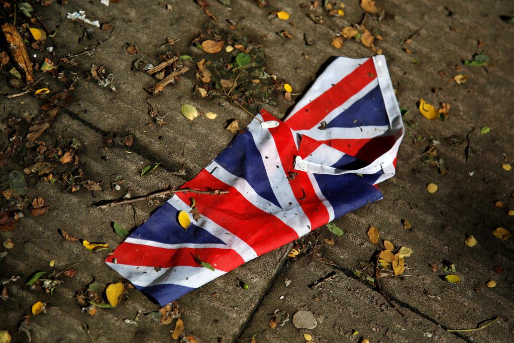 A British flag which was washed away by heavy rains the day before lies on the street in London, Britain, June 24, 2016 after Britain voted to leave the European Union in the EU BREXIT referendum.