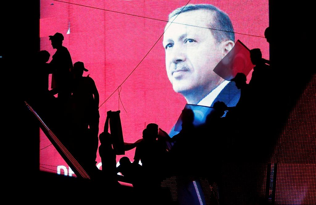 Turkish Supporters are silhouetted against a screen showing President Tayyip Erdogan during a pro-government demonstration in Ankara, Turkey, July 17, 2016.