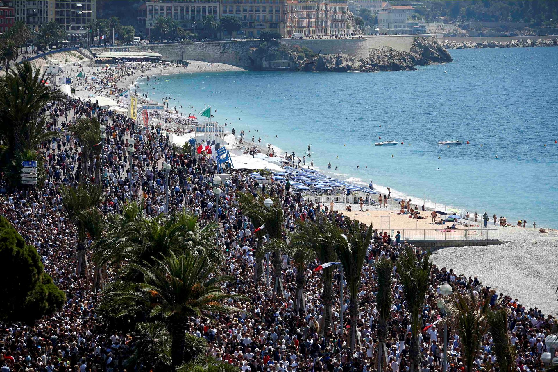 A general view shows the crowd gathering on the Promenade des Anglais during a minute of silence on the third day of national mourning to pay tribute to victims of the truck attack along the Promenade des Anglais on Bastille Day that killed scores and inj