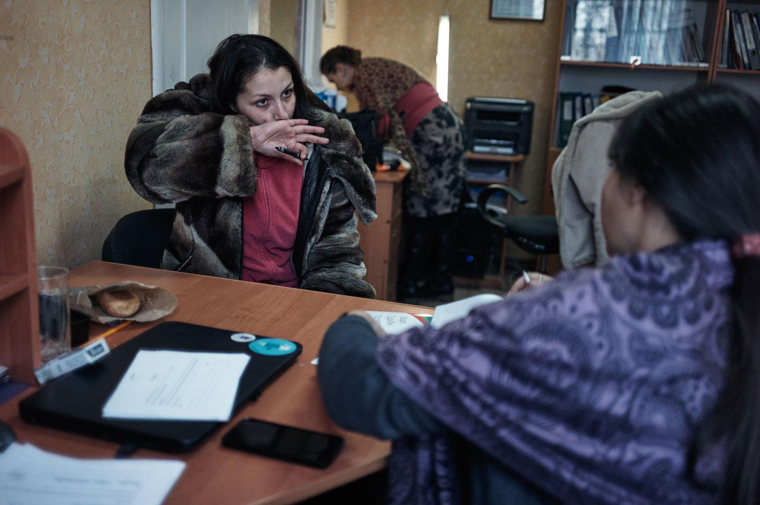 Irina, 28, (left) fled the war from Enakievo, a town now under separatist control in eastern Ukraine. She is an intravenous drug user and receives substitution therapy which was made illegal by separatists. NGO Svitanok Club assists her in her hometown Kr