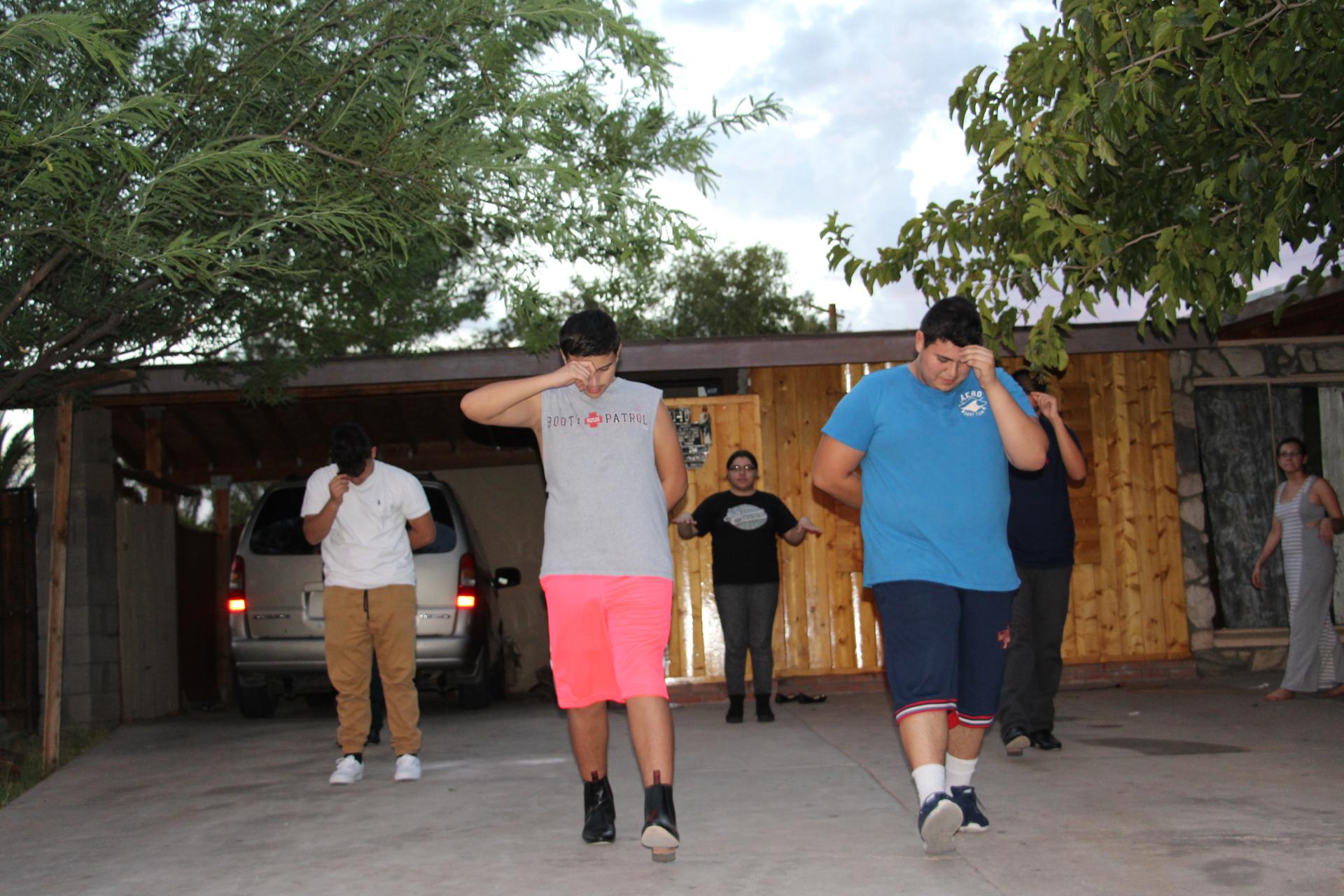 Five out of six of Kimberly's chambelanes run through their zapateado routine on a Friday night. They've been practicing since May for a September quince.